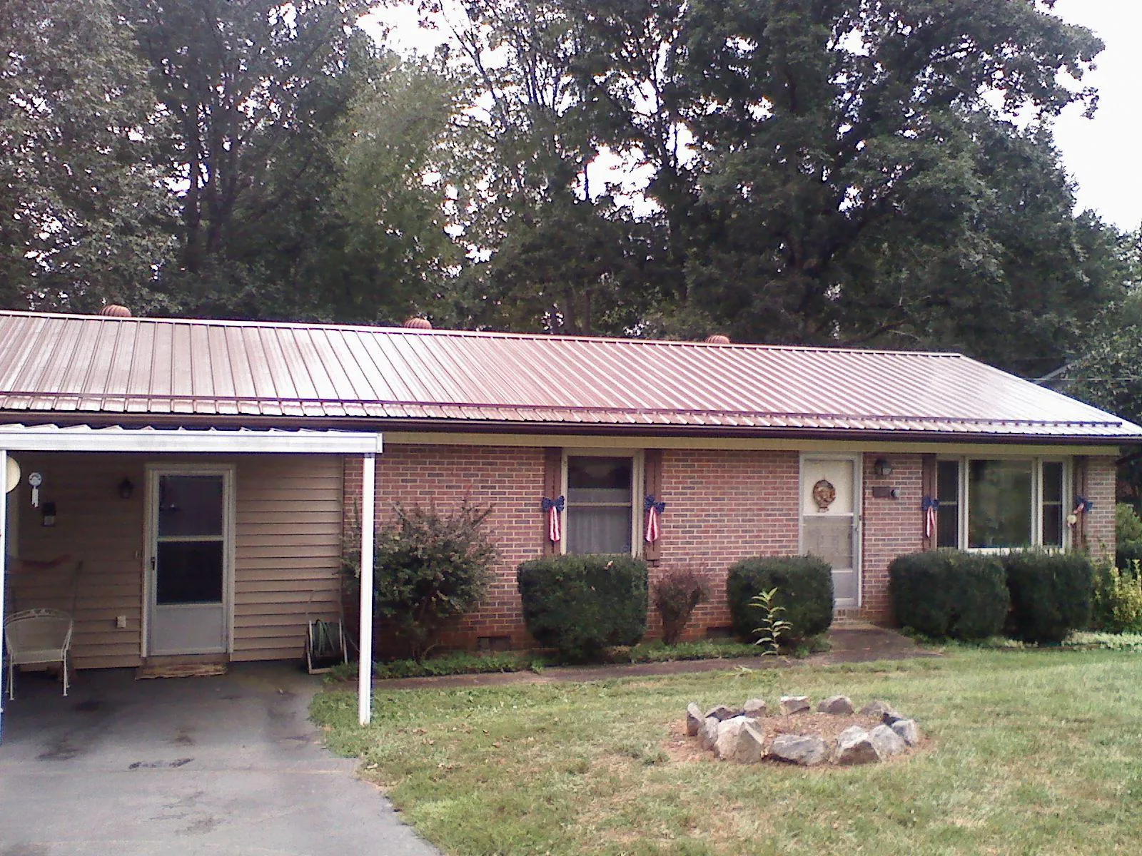 Bronze metal roof and carport on a brick ranch home — Roof Repair work by our crew in Jim Thorpe